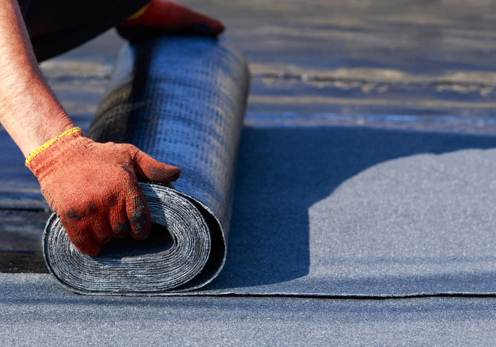 The worker puts roofing material in the open air